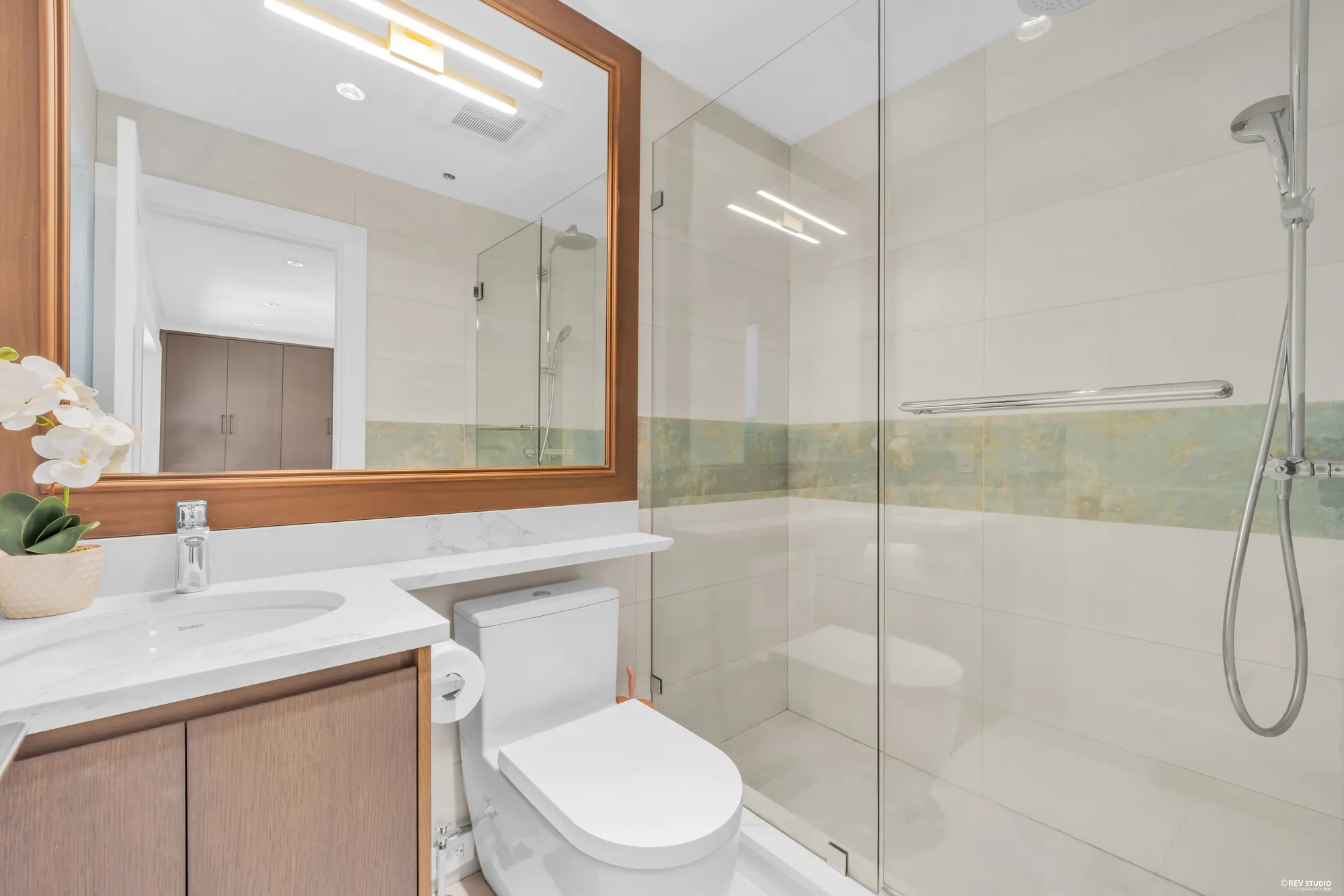 The second smaller upper bathroom, glass shower beside the basin