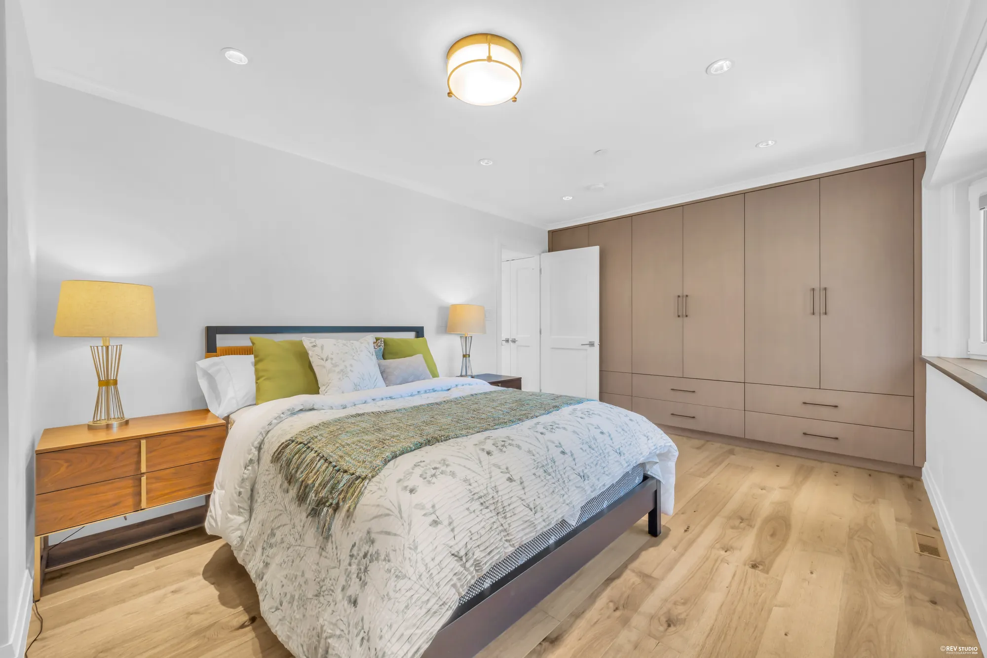 A second upper-floor bedroom with a wall of built-in wardrobes