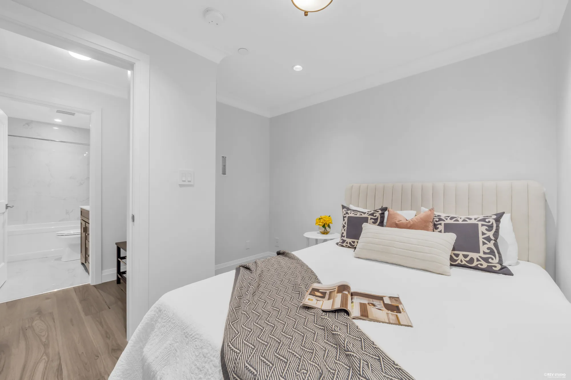 The lower-floor bedroom, the bathroom visible through the opening on the left