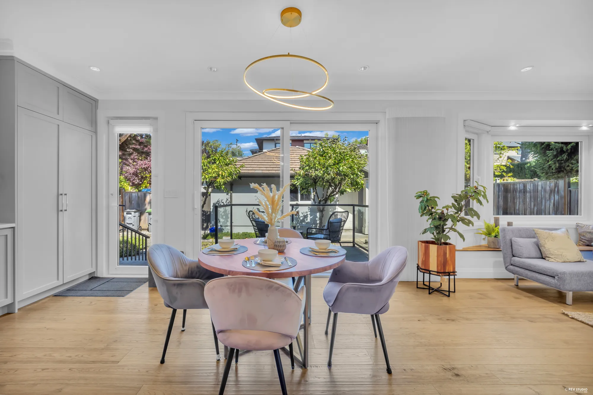 The breakfast area with a round table, windows and doors to the deck