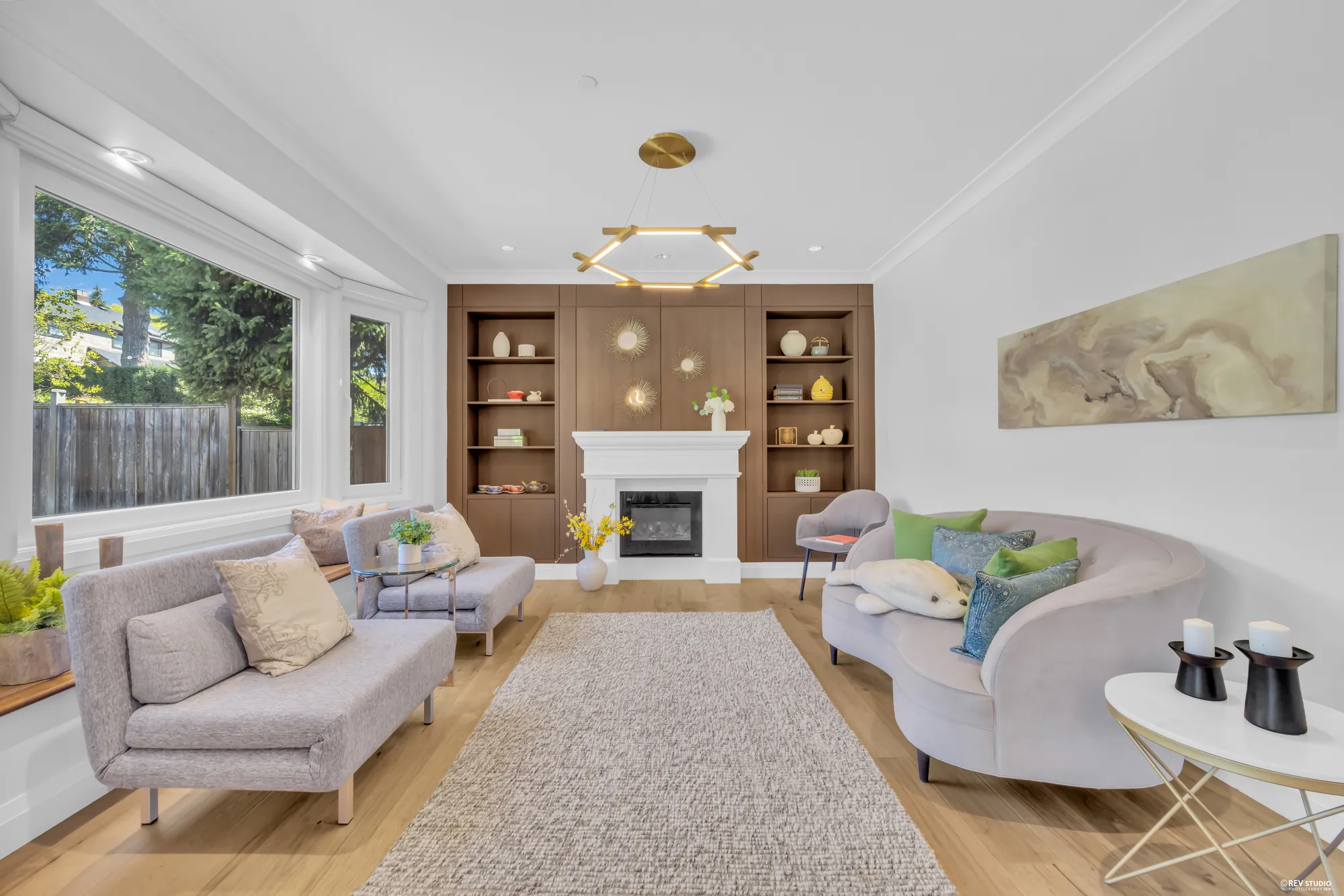 The family room with a gas fireplace flanked by oak built-in shelving