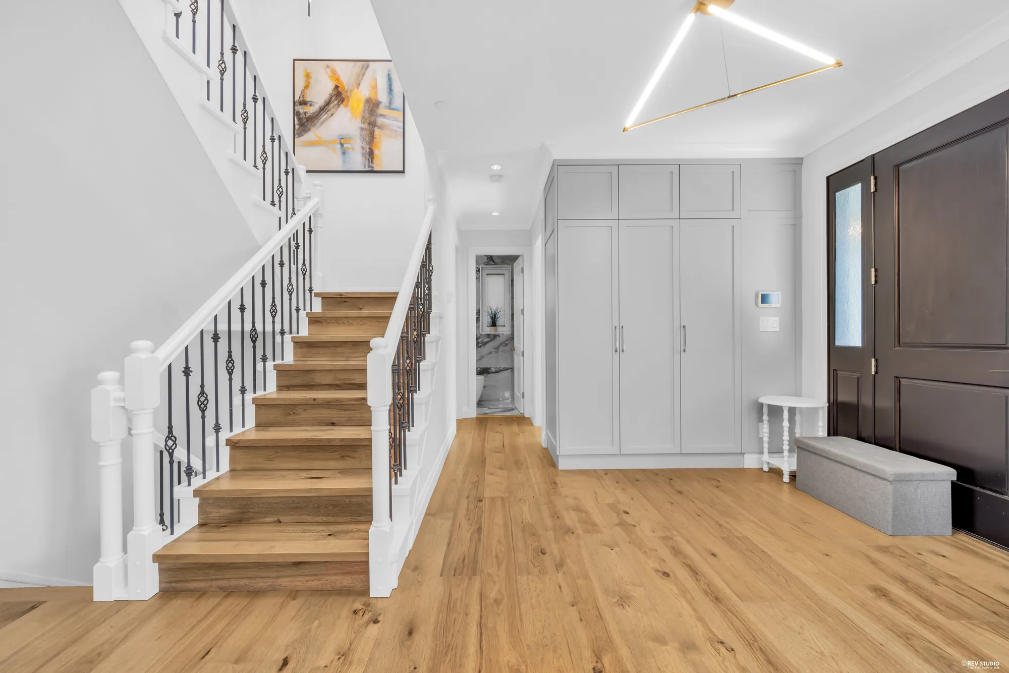 The entrance hall with the front door and the staircase rising to the right