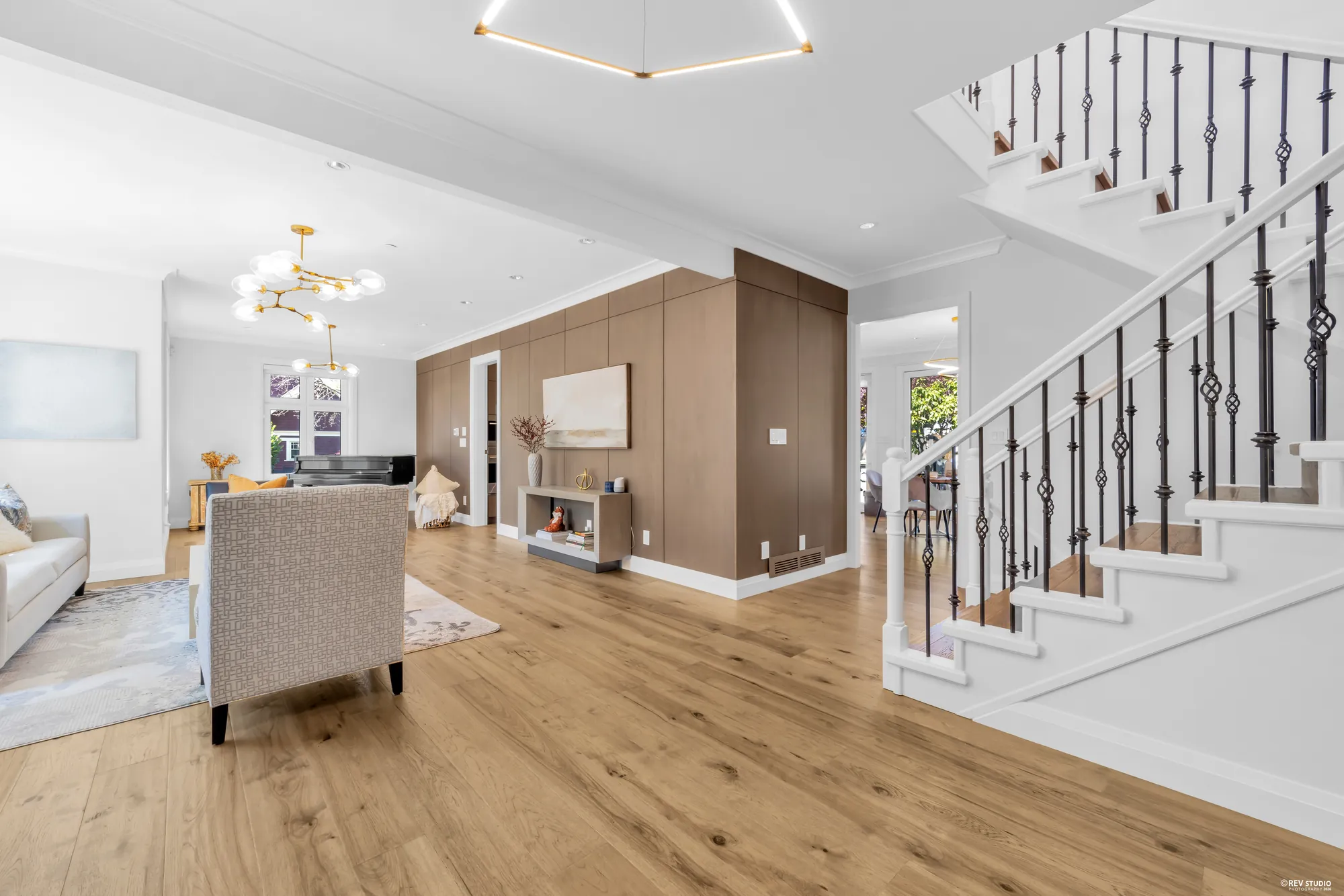 The hall looking past the wood-panelled partition toward the living room, staircase on the right