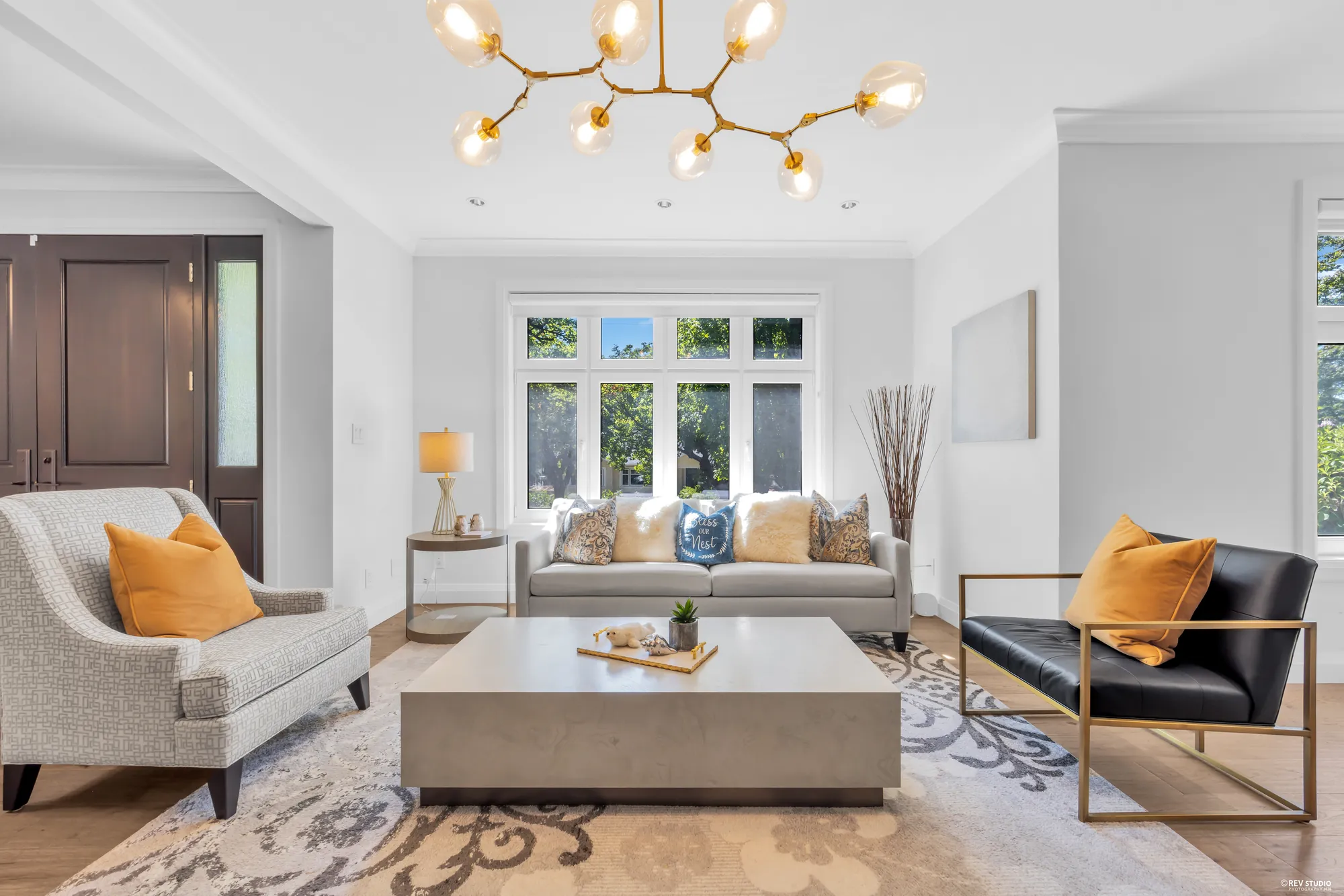 The living room with a bay window to the front garden and the front door beyond