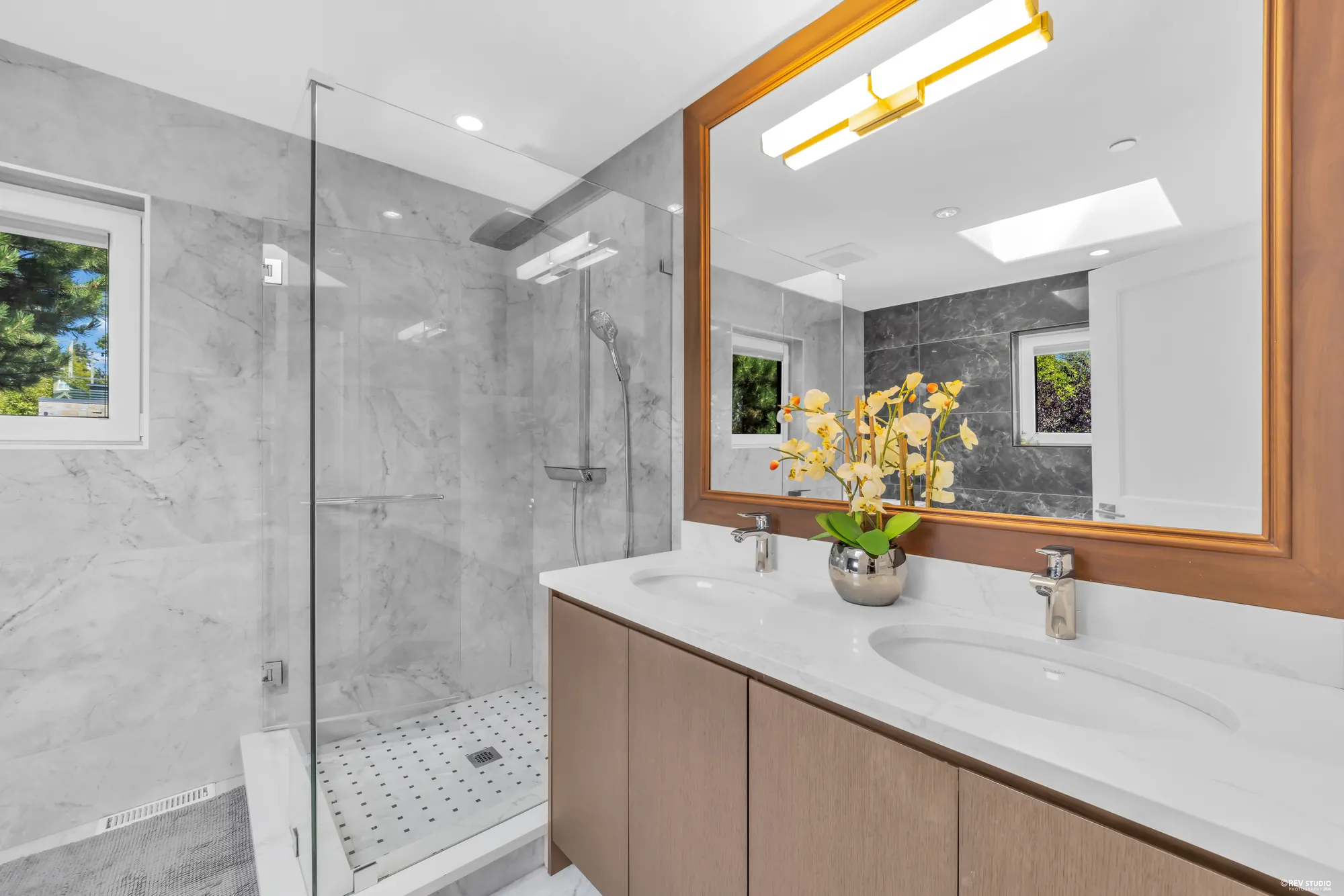 The double vanity and walk-in shower in the primary bathroom