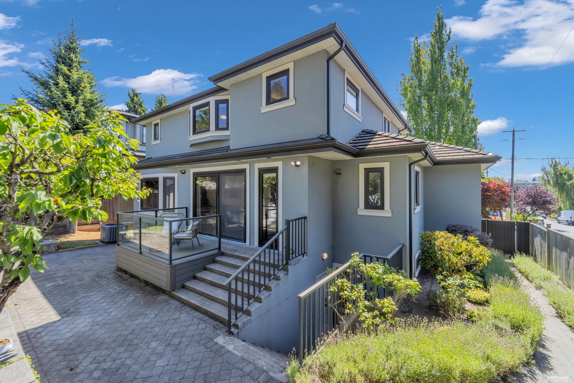 The rear elevation from the far side of the paved yard