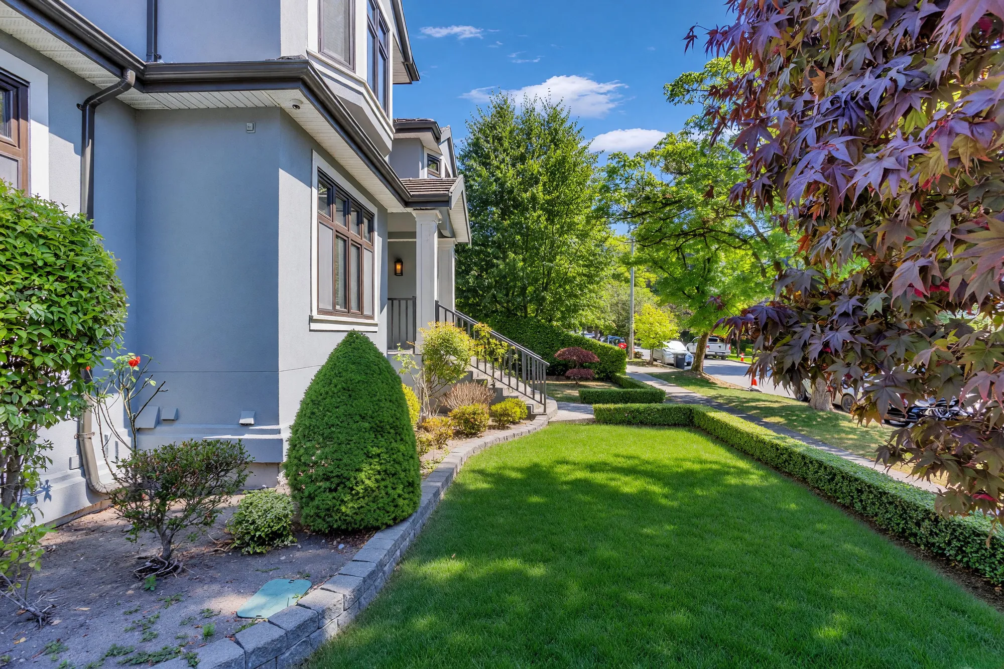 The side lawn and path running along the flank of the house toward the street